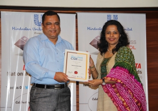 Minister presenting Parvish the award