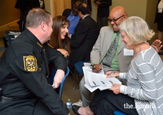 Police officers, clergy, educators, and community peacebuilders discuss implicit bias in group break-out sessions.