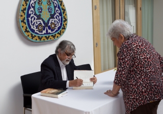 Author M.G. Vassanji sigs copies of his latest memoir at a March 2015 event held at the Ismaili Centre. Shafiq Shamji