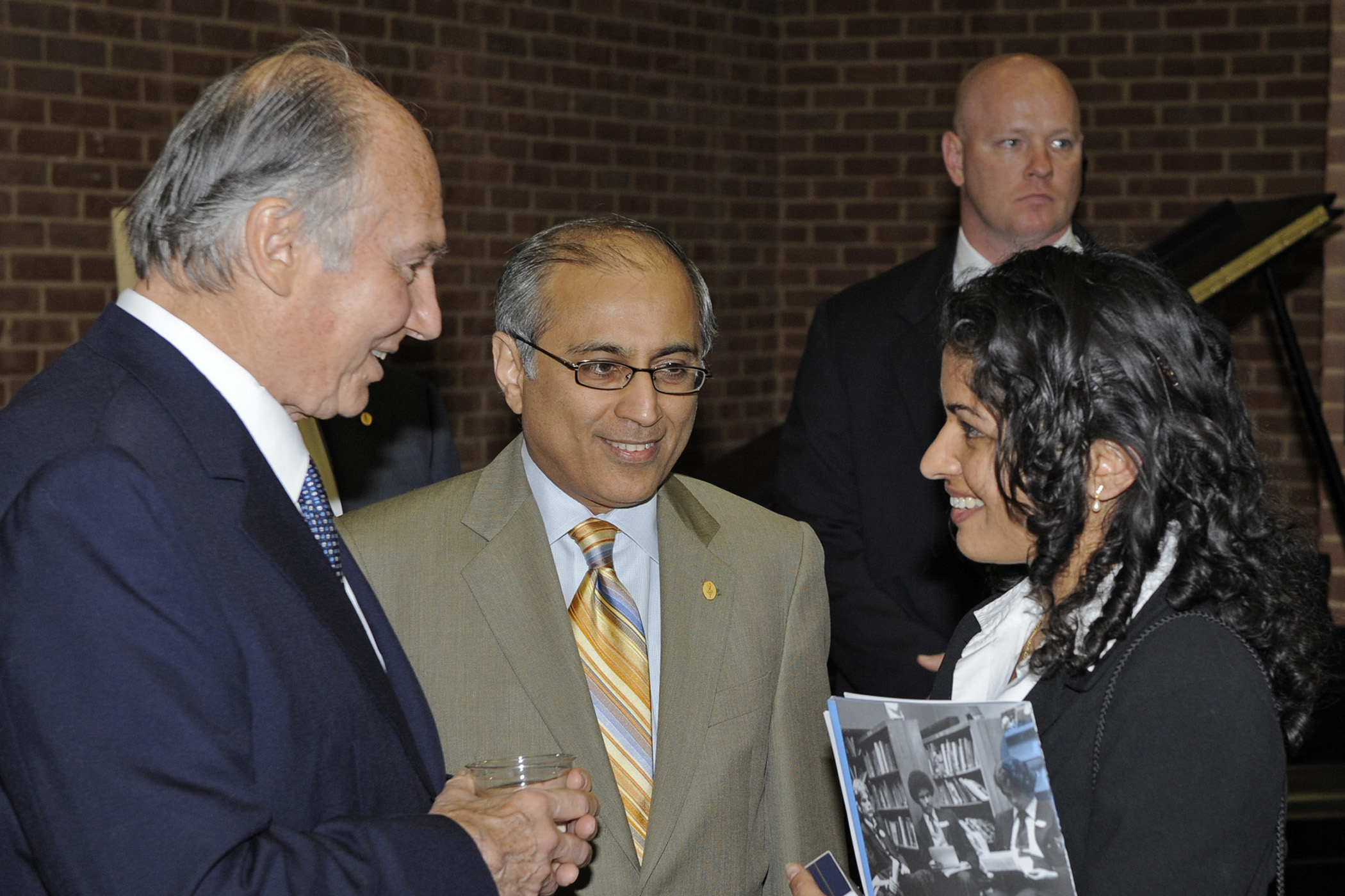 Mawlana Hazar Imam in conversation with an Ismaili involved in the field of Education at the reception following the IBO meeting. Salim Bhatia, Director of the Aga Khan Academies Programme looks on. Photo: Gary Otte