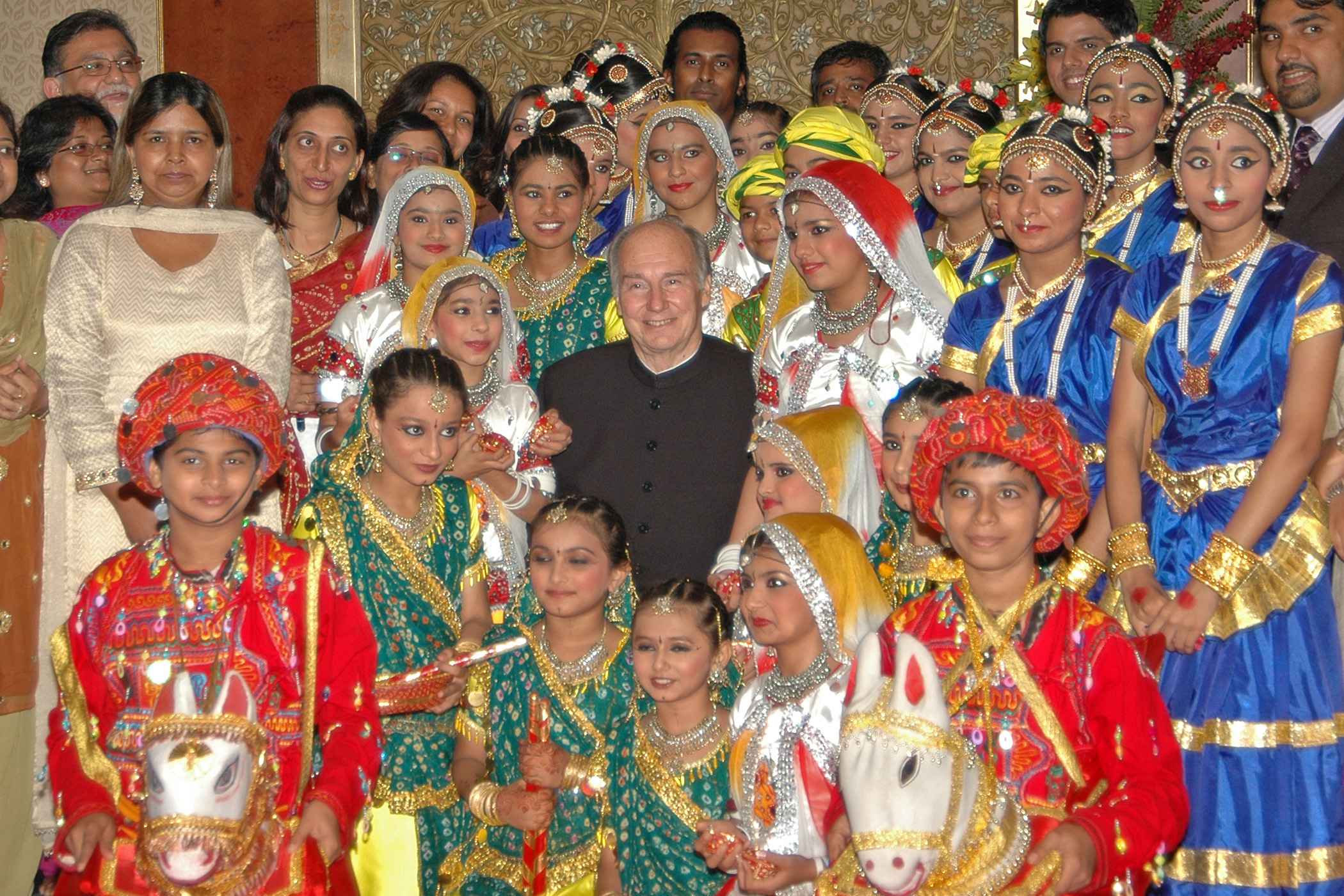 Mawlana Hazar Imam together with performers who had danced earlier in the evening at the Jamati institutional dinner. Photo: Rafiq Khimani