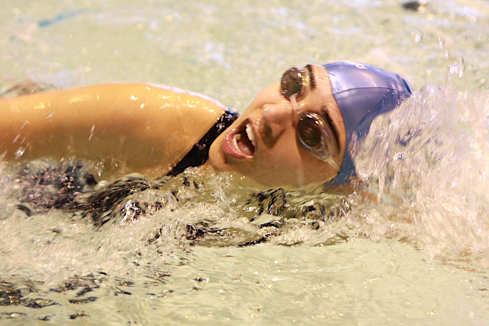 A swimmer fights hard to reach the end of a relay. Photo: Asif Bhalesha and Michelle Penny