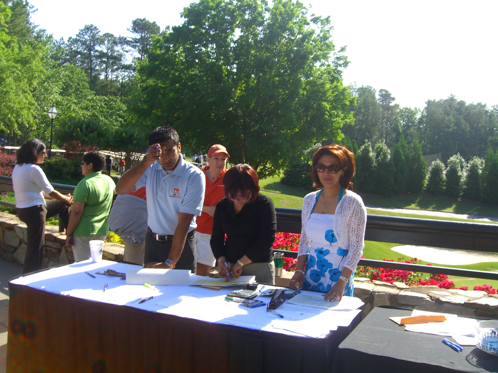 Volunteers prepare to register golfers at the tournament. Photo: Courtesy of AKF-USA