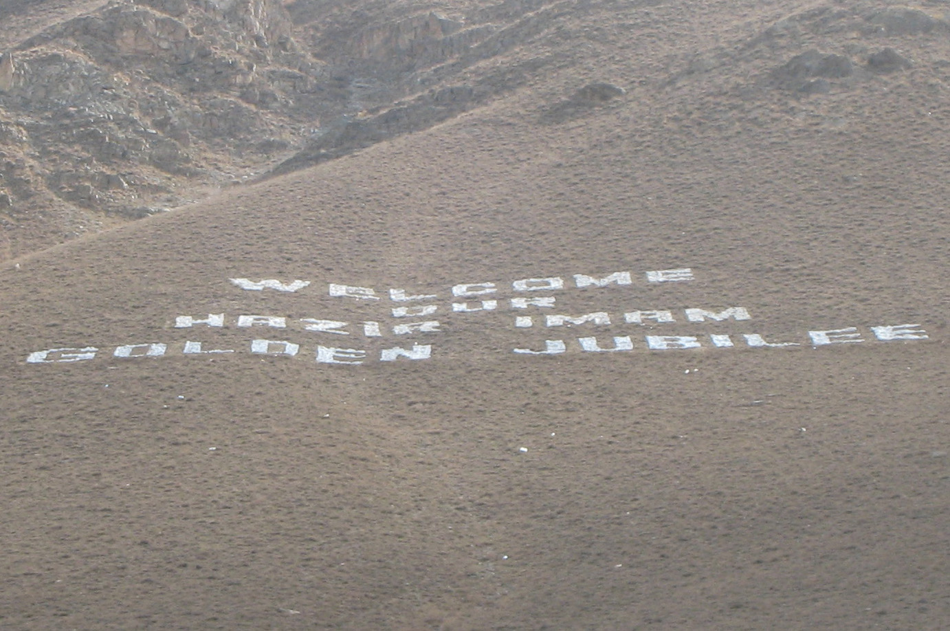 A mountain-side sign built from stones by the Khorog Jamat will welcome Mawlana Hazar Imam on his Golden Jubilee visit to Tajikistan. Photo: Gordon Cumming