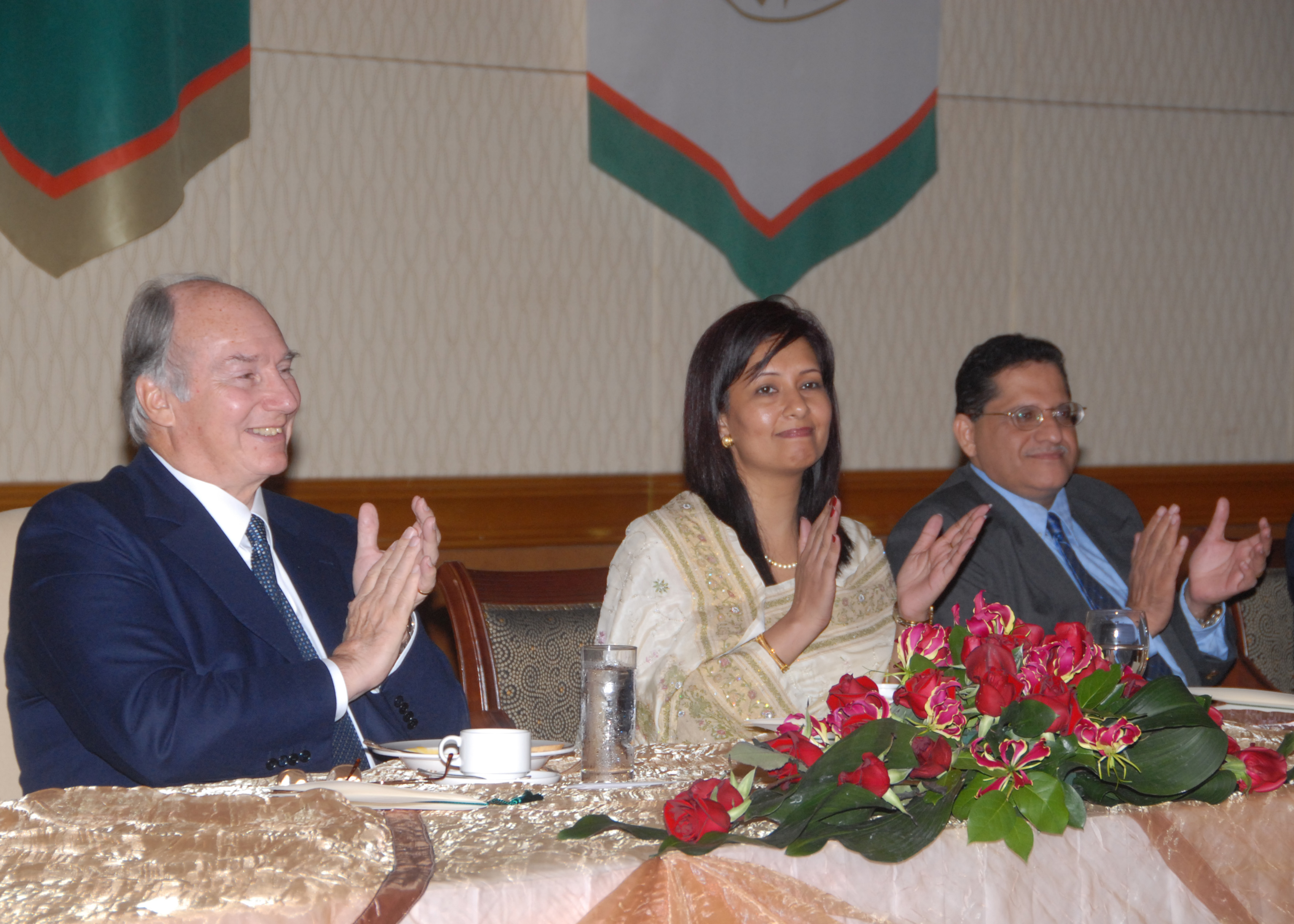 Mawlana Hazar Imam is joined in applause by Presidentbanoo and the Vice-President of the Ismaili Council for Malaysia and Singapore, during a luncheon hosted by the Jamati institutions. Photo: Akbar Hakim