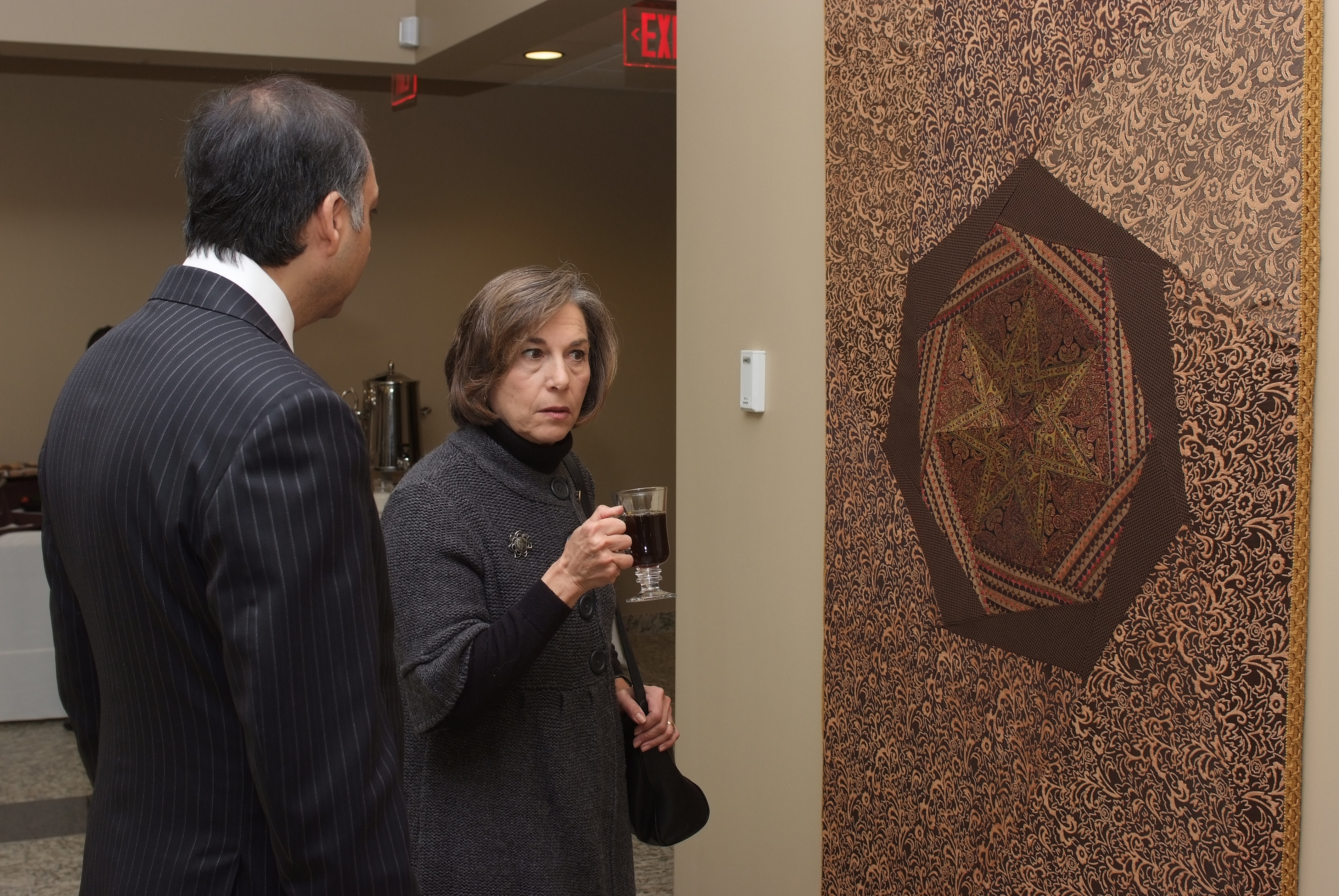 Congresswoman Jan Schakowsky and President Mahmoud Eboo admire a tapestry stitched by volunteers from the Jamat. Photo: Anwar Merchant