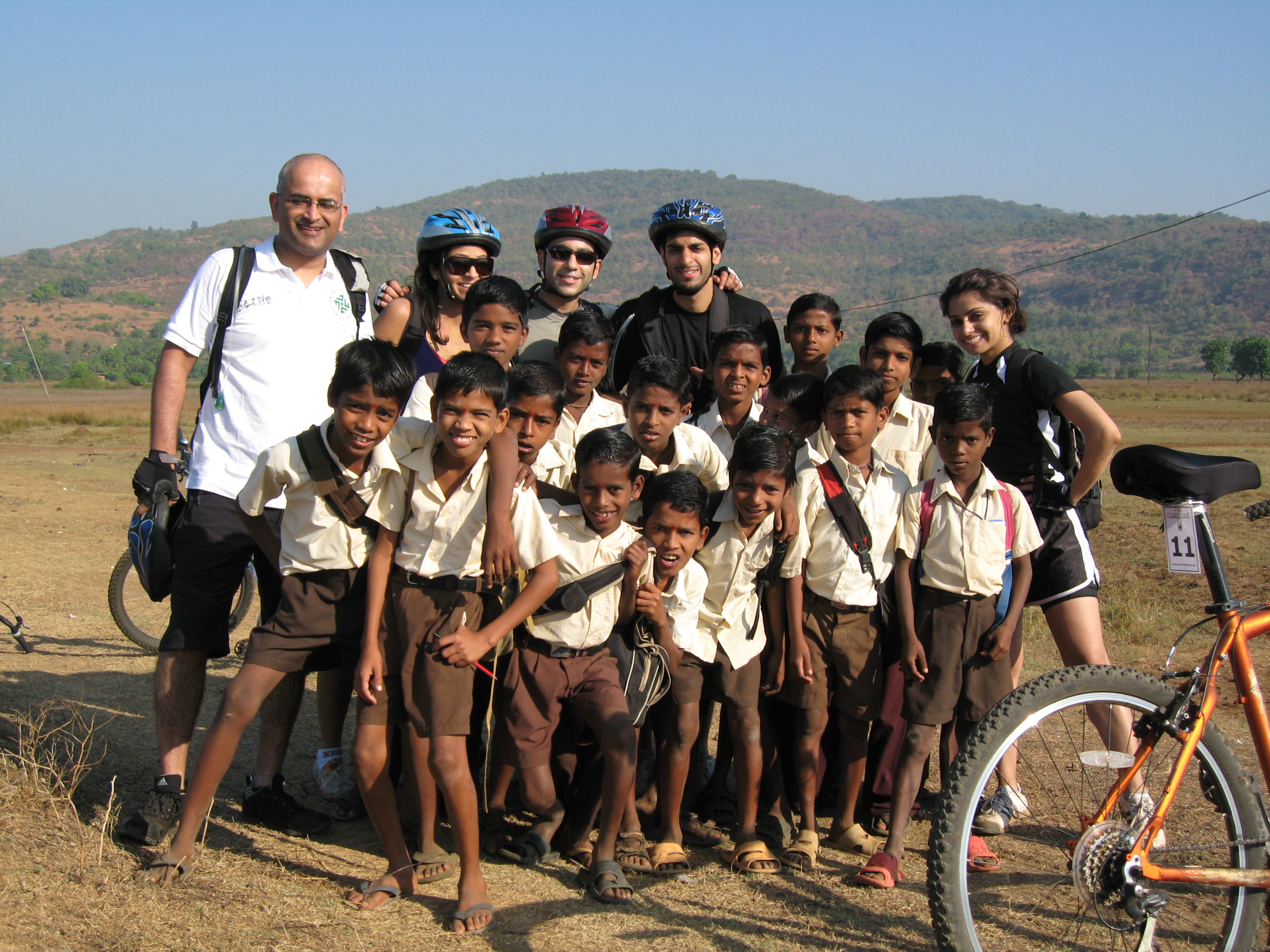 Along the route, bikers found different ways to rest and recuperate. Some found respite under the shade of a tree, while others played games with nearby children, sampled local delicacies or posed for yet more photographs!. Photo: Courtesy of Pehmaneh Ramji