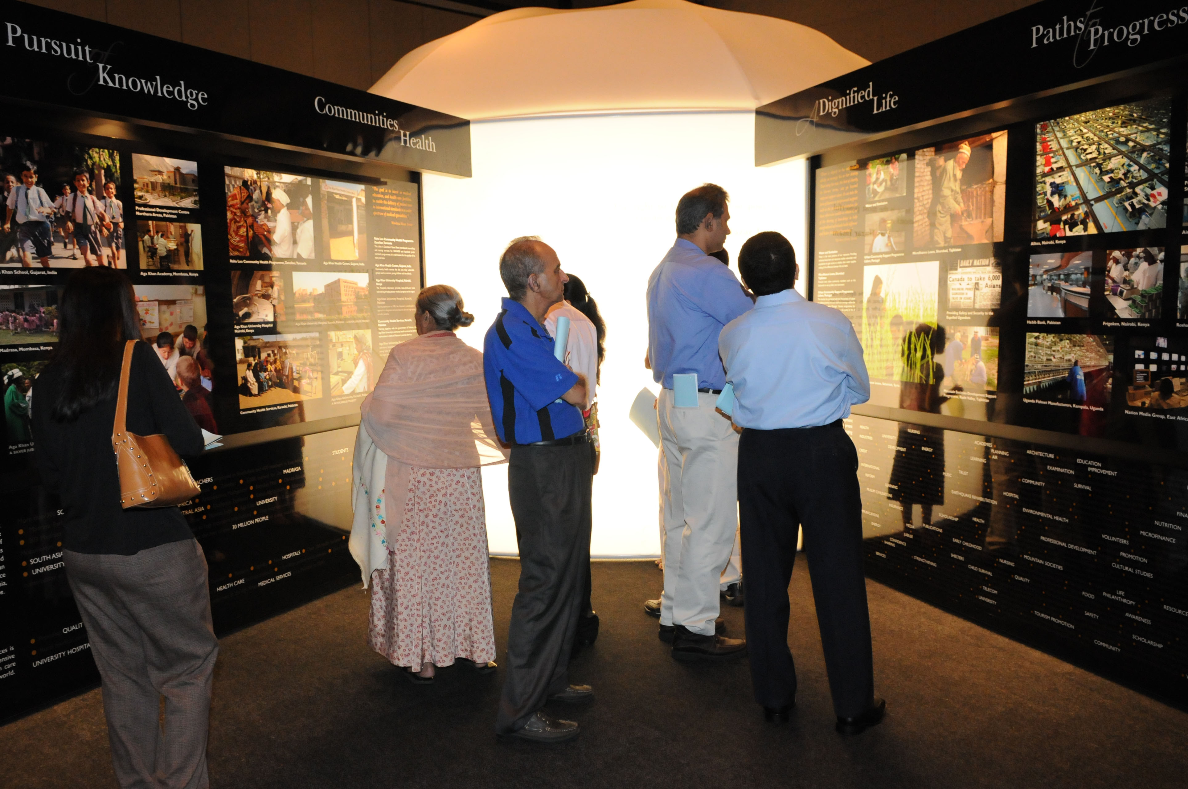 Visitors examine photographs illustrating some of the work that Mawlana Hazar Imam has undertaken during the past 50 years. Photo: Courtesy of the Ismaili Council for the USA