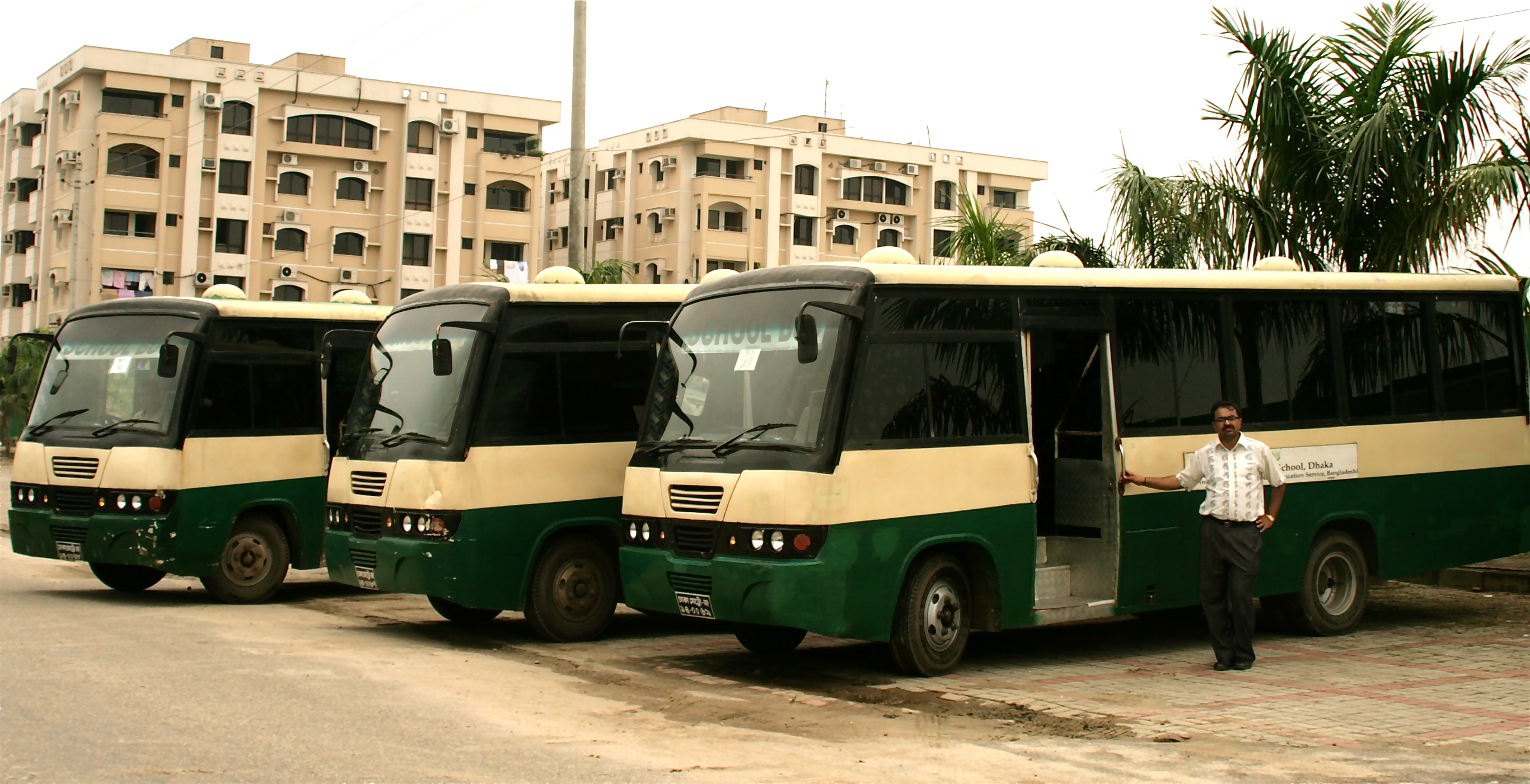 Karim Noorddin stands in front of three buses from the transport business that he and his brother established in 2007. Photo: Ayeleen Ajanee Saleh