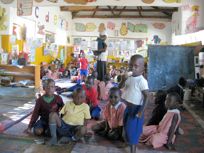 Children prepare for snack time at an AKF Madrasa Programme preschool in Uganda. Photo: Courtesy of Shamim Murji