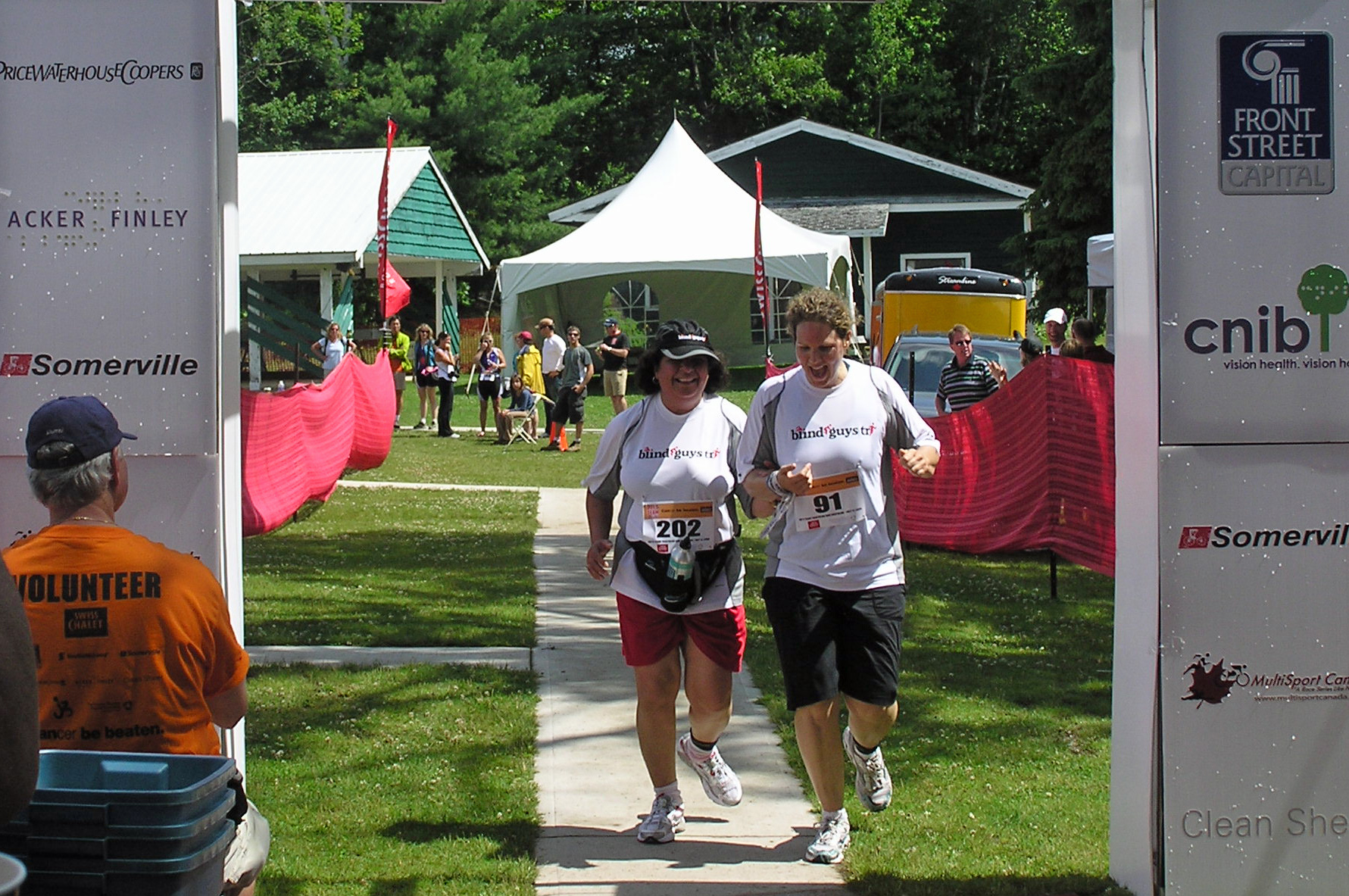 Rozina Issani and her guide Kate cross the finish line at the third annual Joe's Team Triathlon in Muskoka, Ontario. Photo: Courtesy of Rozina Issani