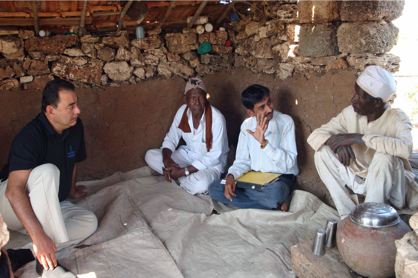 Munir Samji speaks with to two Siddhi farmers. With advice and assistance from AKRSP, many of the farmers have improved in their income from the land – in some cases doubling it. Photo: Prashant Joshi