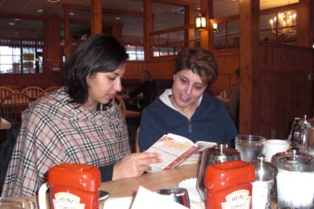 MBS gals, Fauzia Karmali and Zahra Dedhar, engrossed in a discussion of Mitch Albom's, “Have a Little Faith”. Photo: Courtesy of Shairose Gulamani