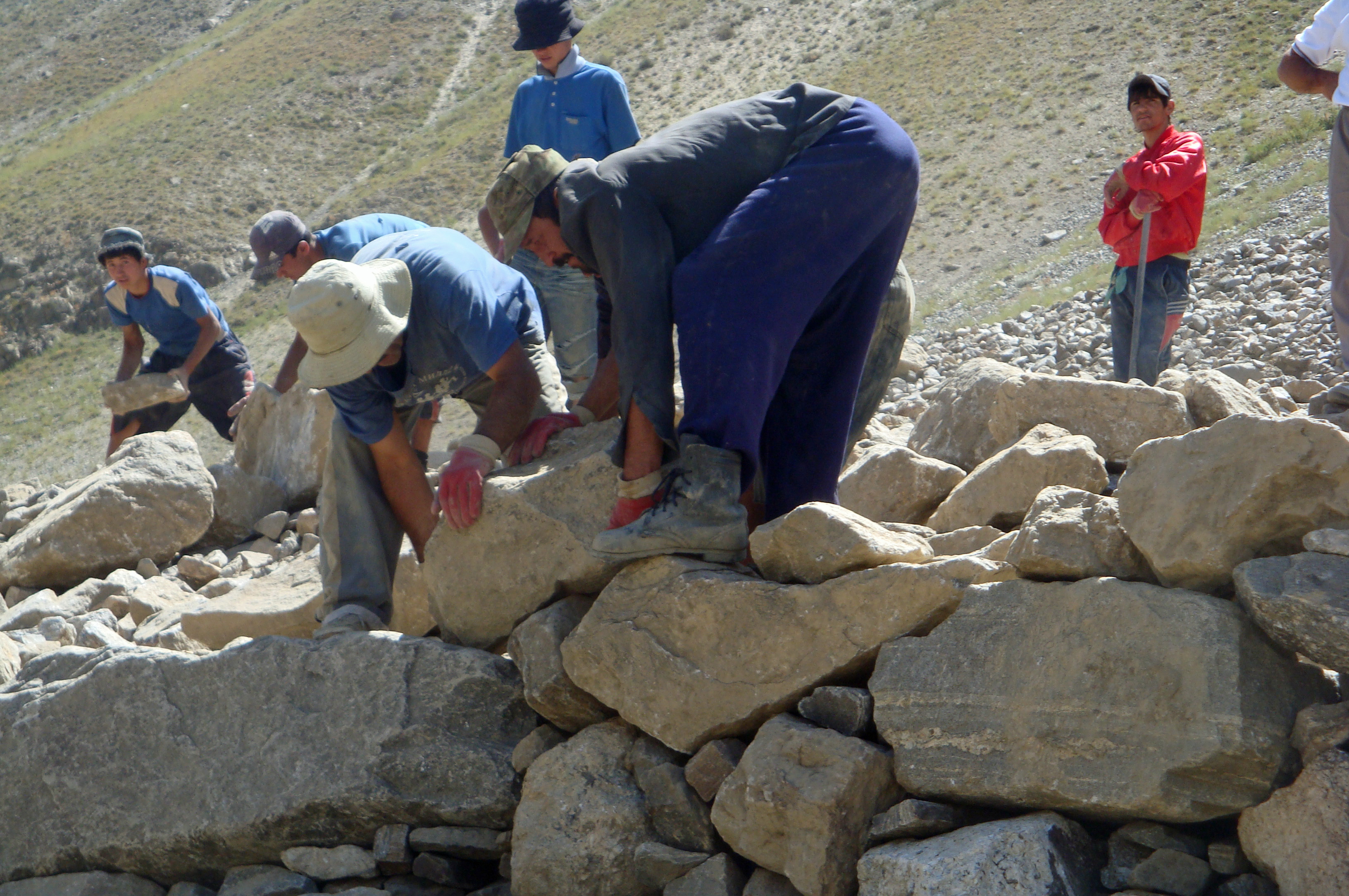 Drawing on a traditional Pamiri custom of public voluntary work known as “kiryar”, members of the community participate in the construction of a reveted wall in Khorog. Photo: Janet Southern