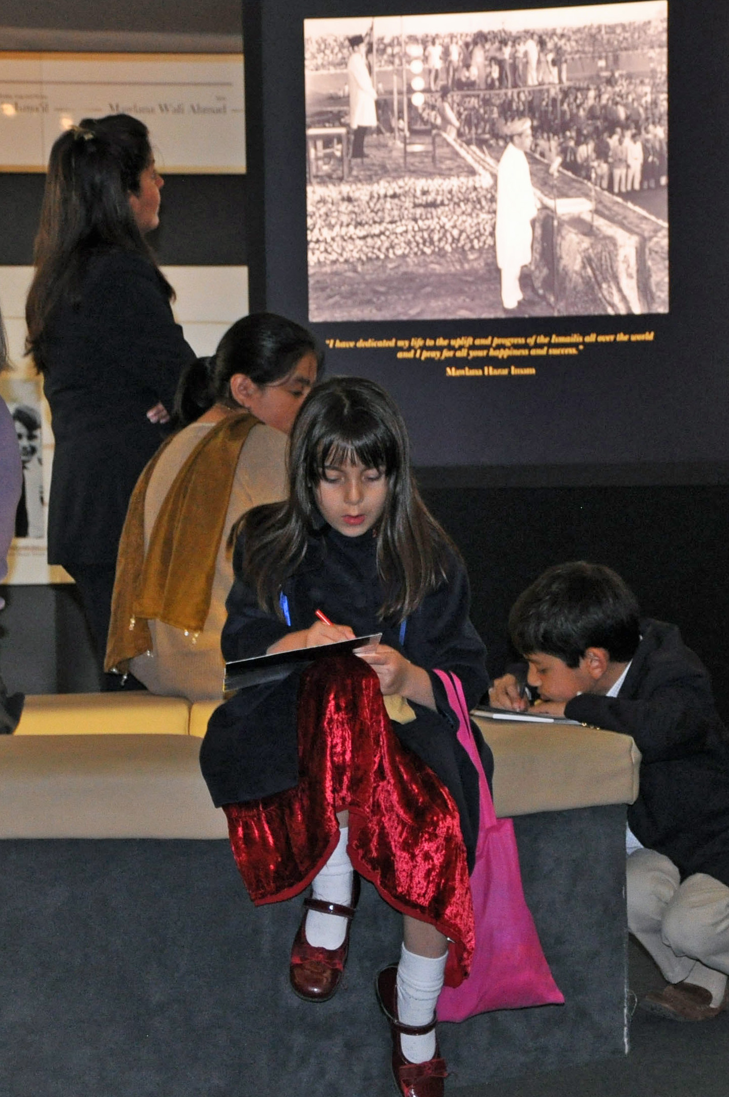 A young girl pauses to take notes in the rotunda at the centre of the RAYS OF LIGHT exhibition. Photo: Nina Hirji Kheraj