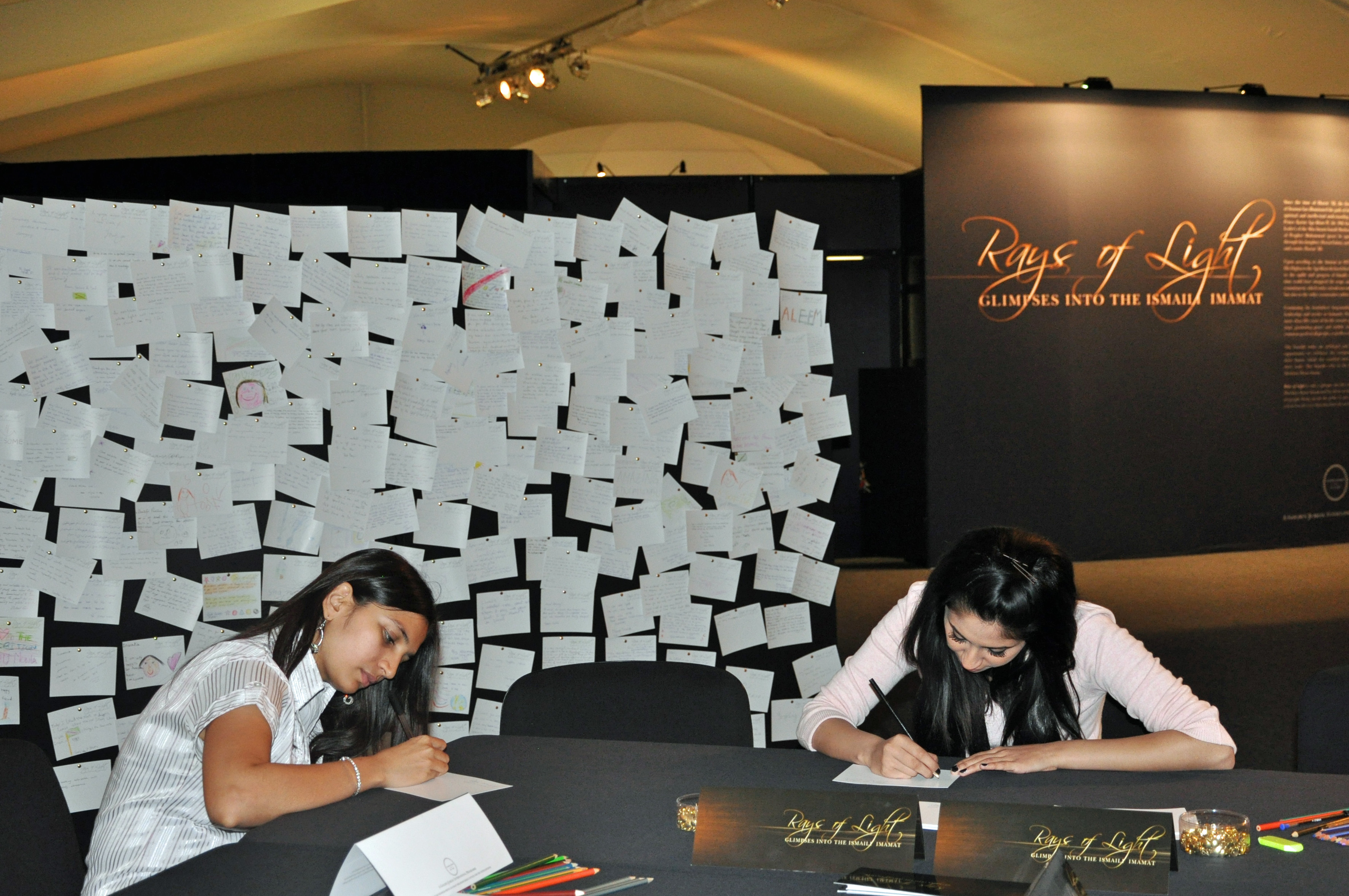 The wall of comment cards outside the RAYS OF LIGHT exhibition has become a display in its own right. Photo: Nina Hirji Kheraj