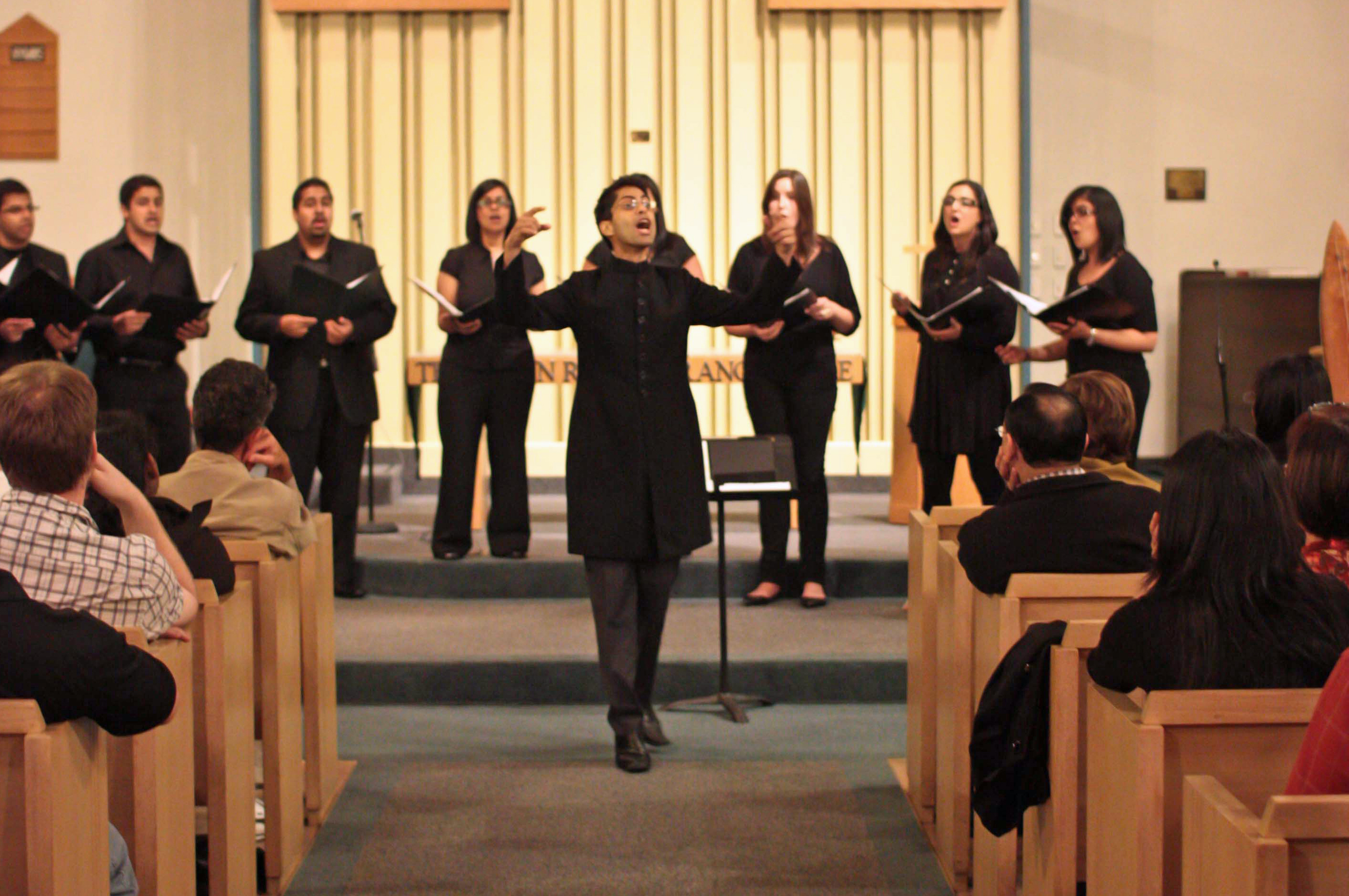 Hussein Janmohamed leads the choir at a Pakistan flood relief benefit concert in Port Moody, BC. Photo: Chelsea Brooke Roisum