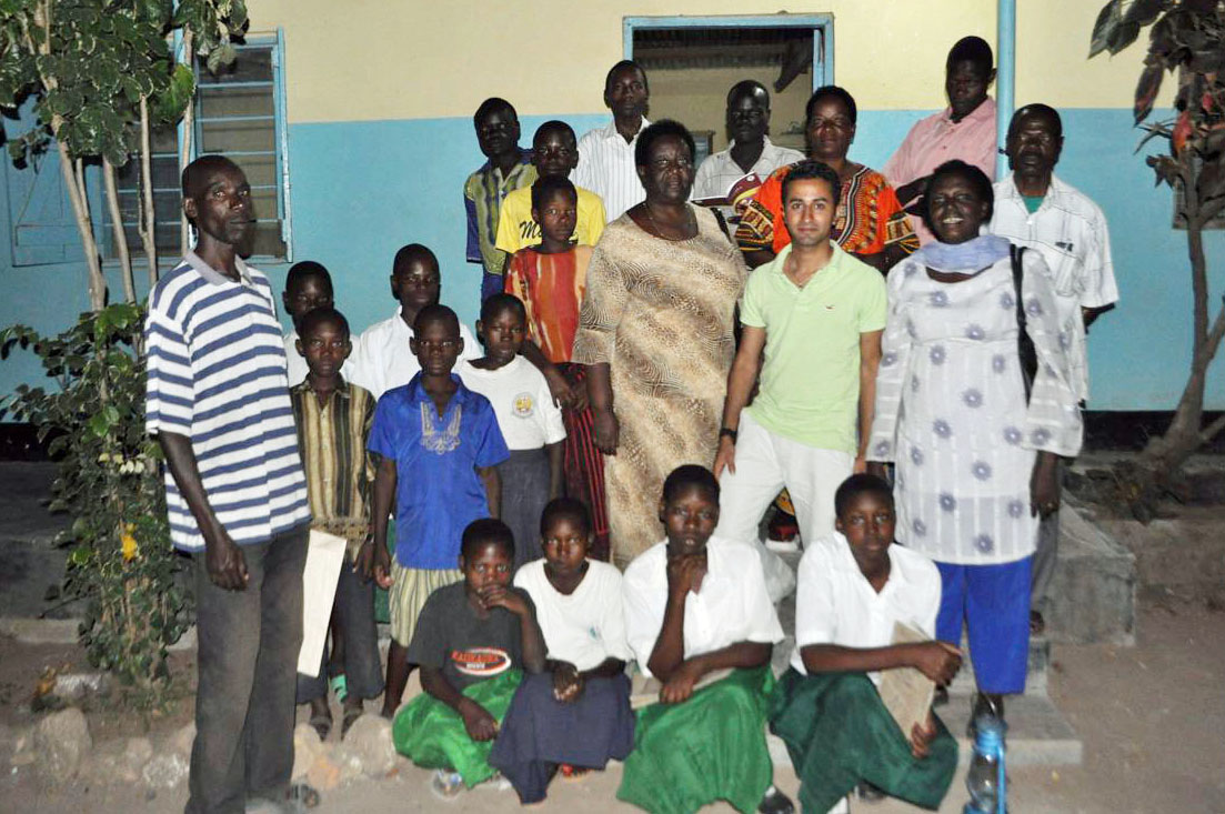 Mawji with teachers and a few students outside Masurura Elementary School, one of the places that received solar panels through Mawji's efforts. Photo: Courtesy of Naeem Mawji