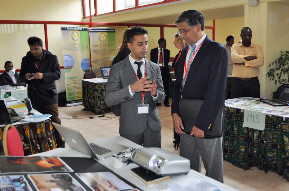 Mawji explains his solar-powered mini grid project to Anil Cabraal, Senior Energy Specialist with the World Bank, at the Bank's Lighting Rural Tanzania Competition. Photo: Courtesy of Naeem Mawji