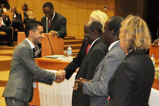 Mawji accepts an award from World Bank's Lighting Rural Tanzania Competition on behalf of his company, Carbon X. Mawji is using the $100 000 grant to connect 50 homes in Masurura to a solar-powered mini-grid. Photo: Courtesy of Naeem Mawji