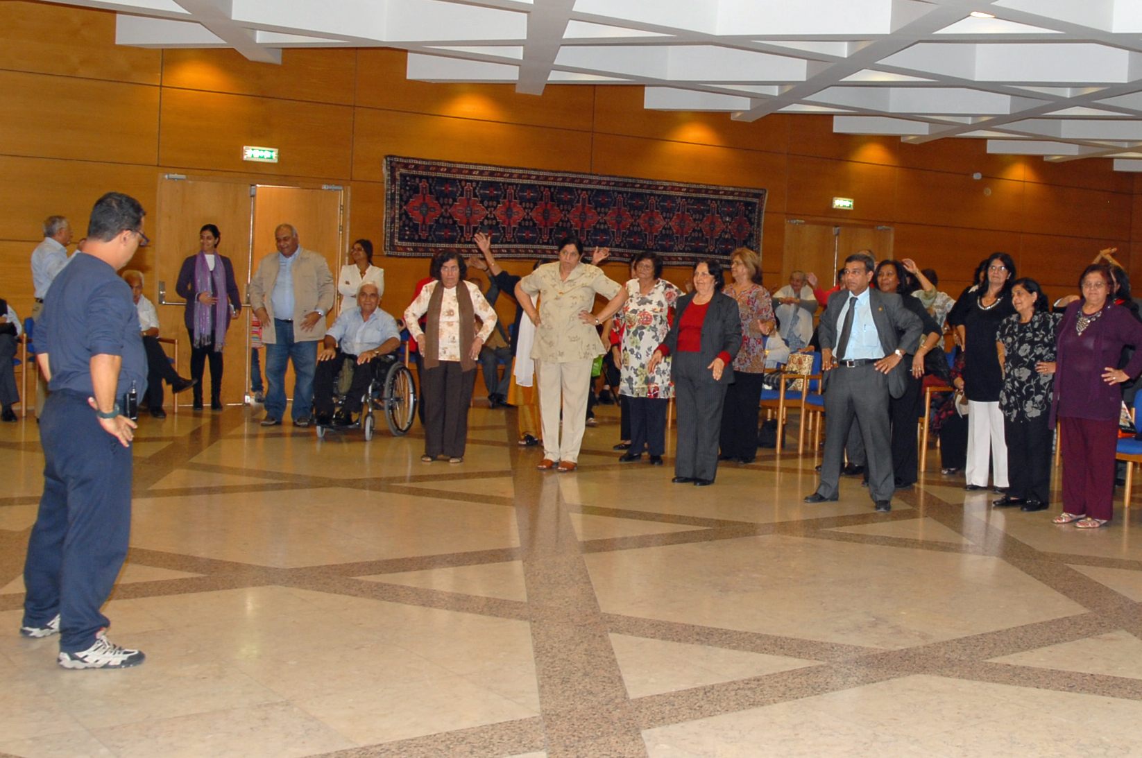 A fitness instructor leads the senior participants in exercises that are particularly suited to their age group. Photo: Pirbhai