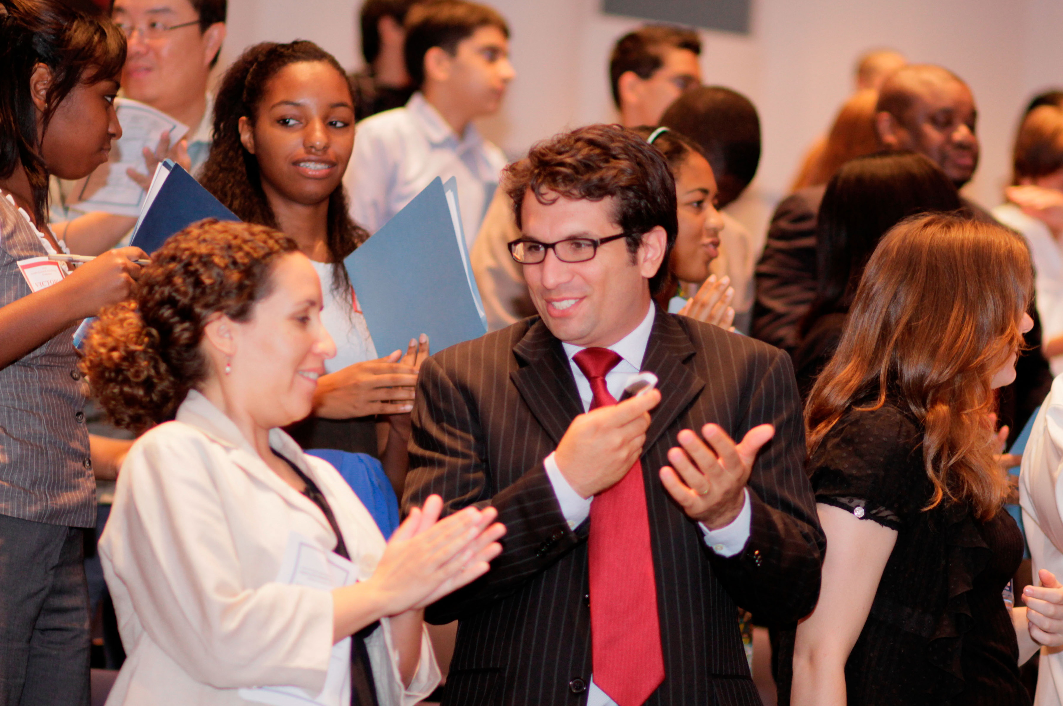 Parents and other guests applaud the Youth Summit speakers. Photo: Bombay Photography