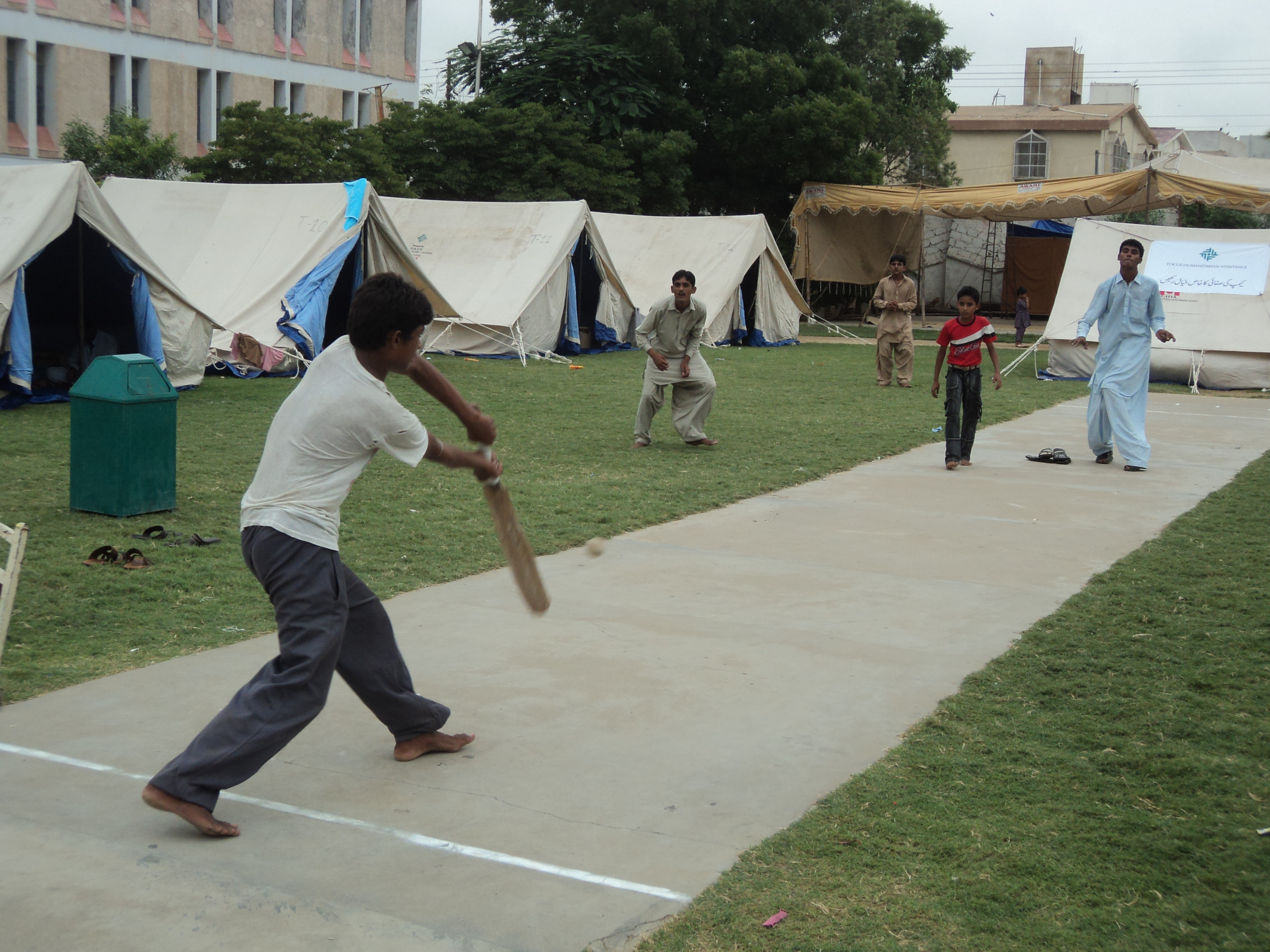 Displaced children from rural parts of Sindh enjoy a game of cricket at a relief camp established at the Aga Khan Gymkhana in Karachi. Photo: Courtesy of FOCUS