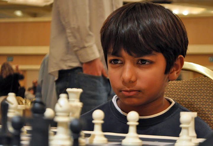 Danial Asaria plays an intense game at a national US chess championship. Photo: MonRoi