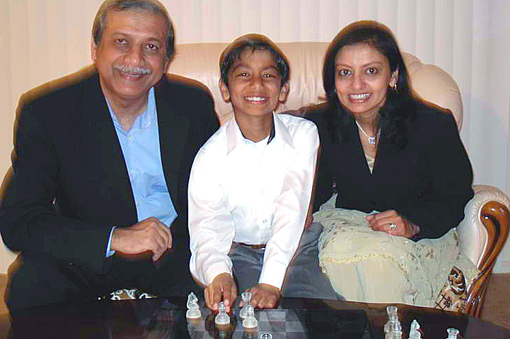 The Asarias with their young chess champion. Photo: Courtesy of the Asaria Family