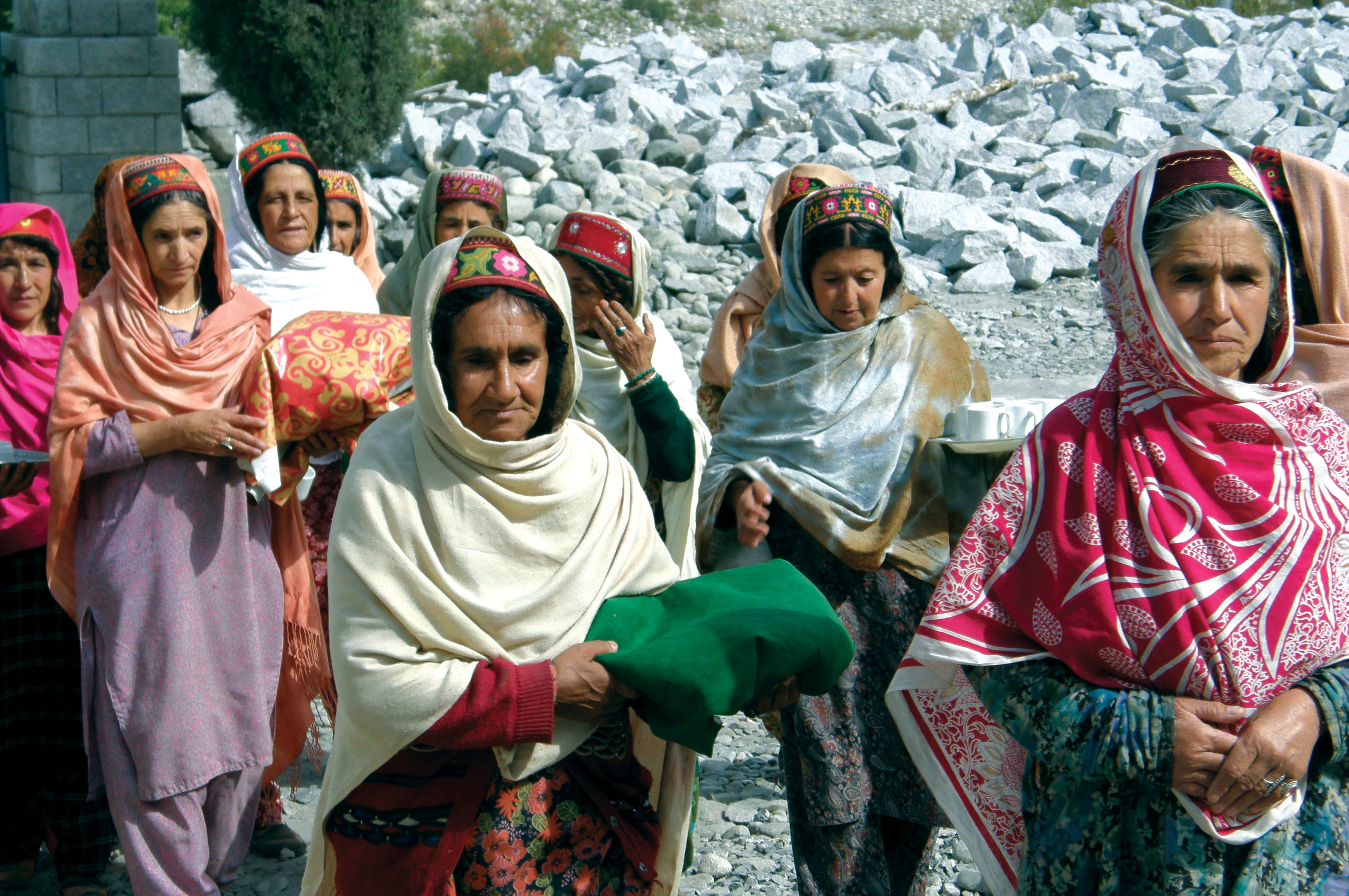 Ismaili women bring food for the Jamati members engaged in construction of a Jamatkhana in Northern Pakistan. Photo: Courtesy of AKPBS, Pakistan