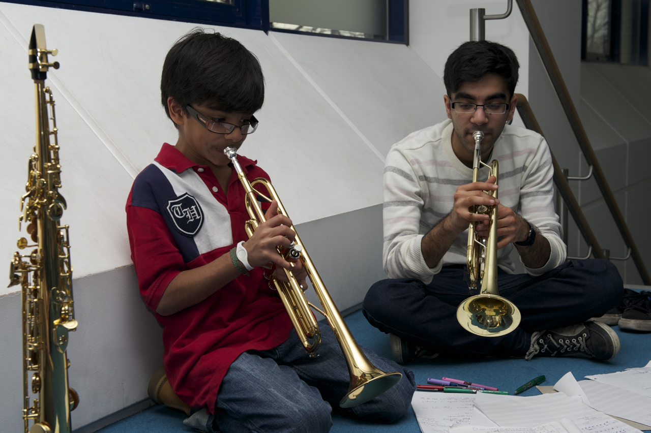 Hussein Meghji offers encouragement to fellow ICE musician Ali Jivraj. Photo: Naveed Osman