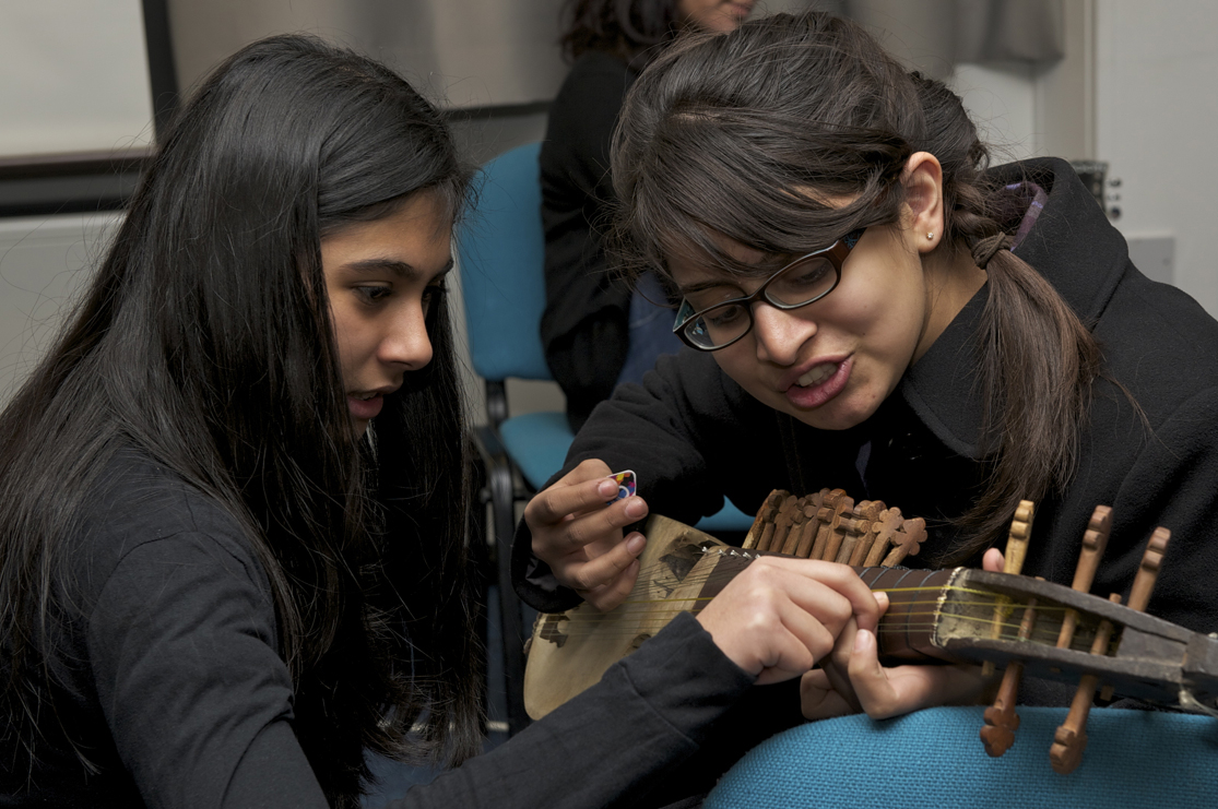 Durri Zahi and Noureen Lakhani work together with a Rubab. Photo: Naveed Osman