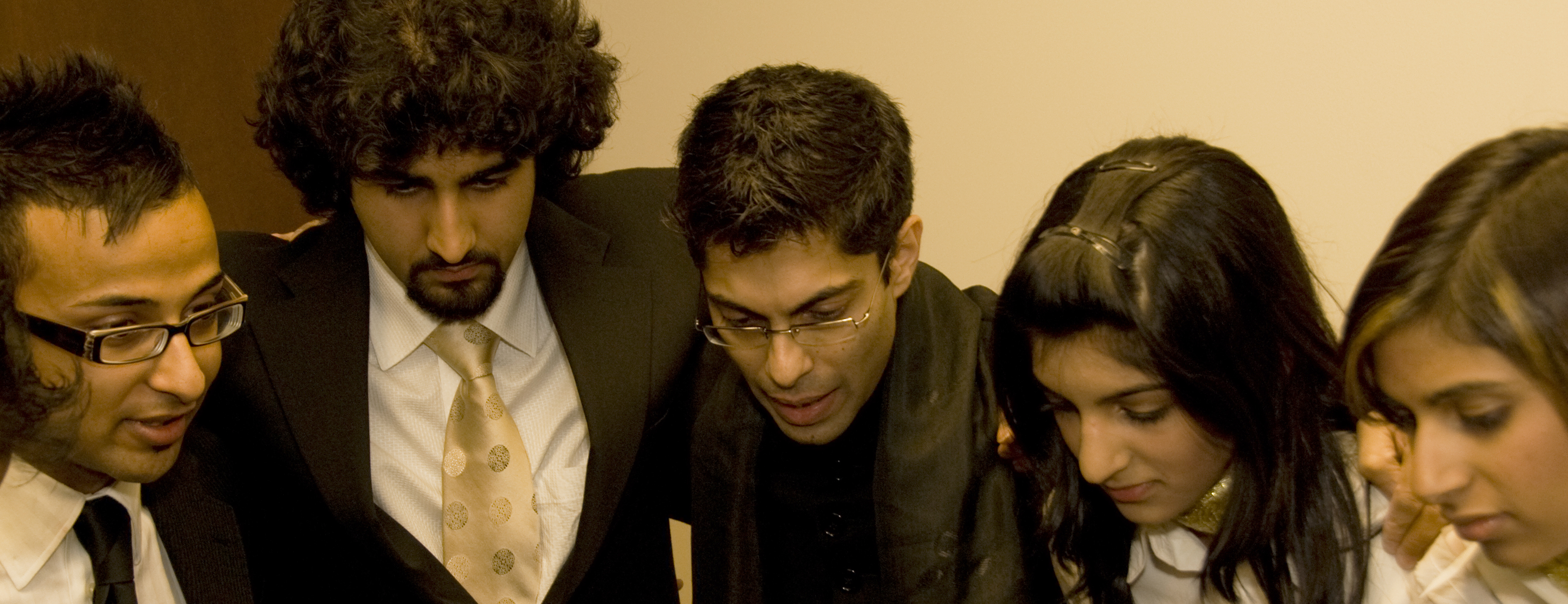 Hussein Janmohamed (centre) in a pre-show huddle with members of the Canadian Ismaili Muslim Youth Choir at a performence in Edmonton. Photo: Phil Musani