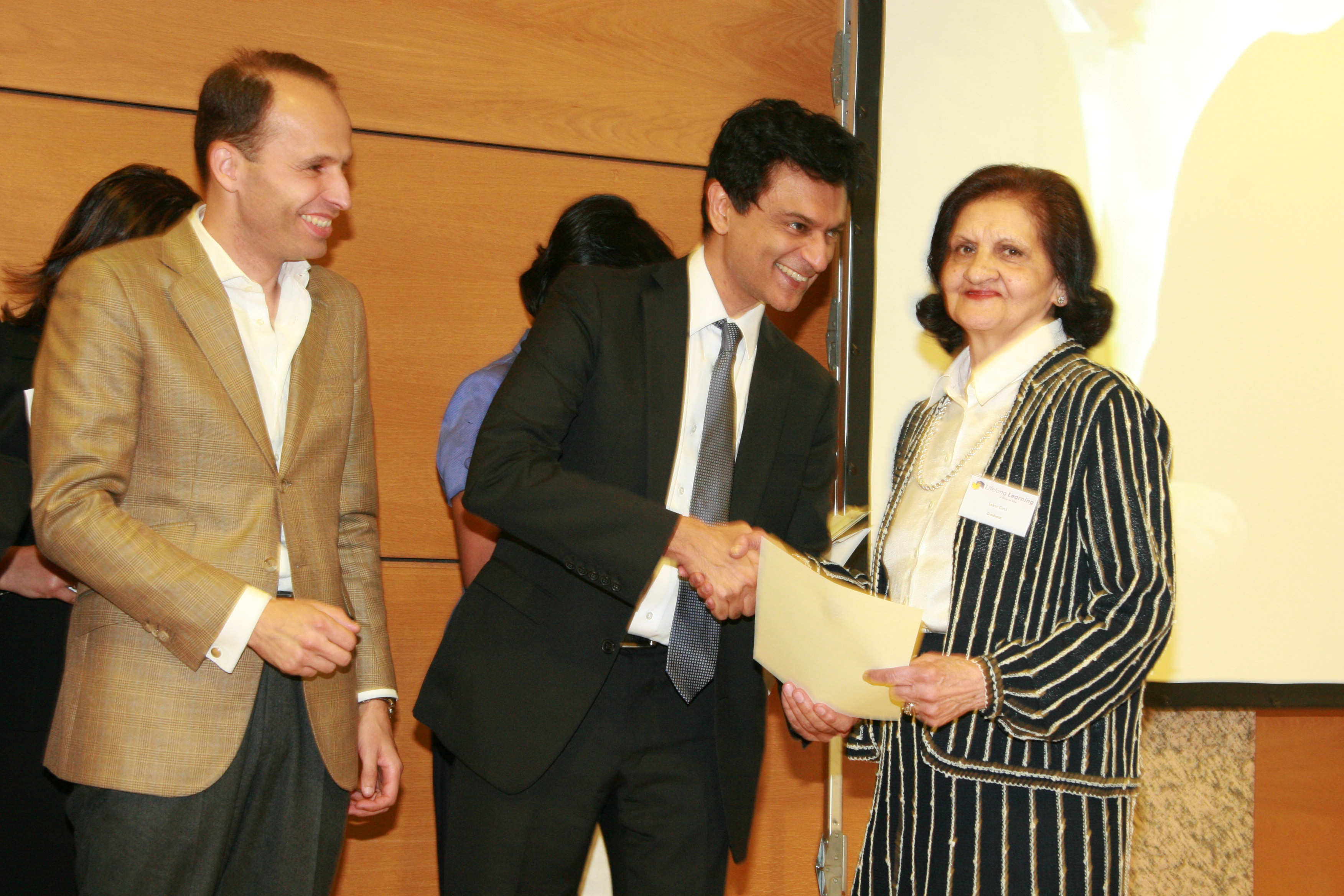 Professor Bhimani and Minister Soares award a Lifelong Learning Certificate to one of the eldest graduates in the programme. Photo: Phirbhai