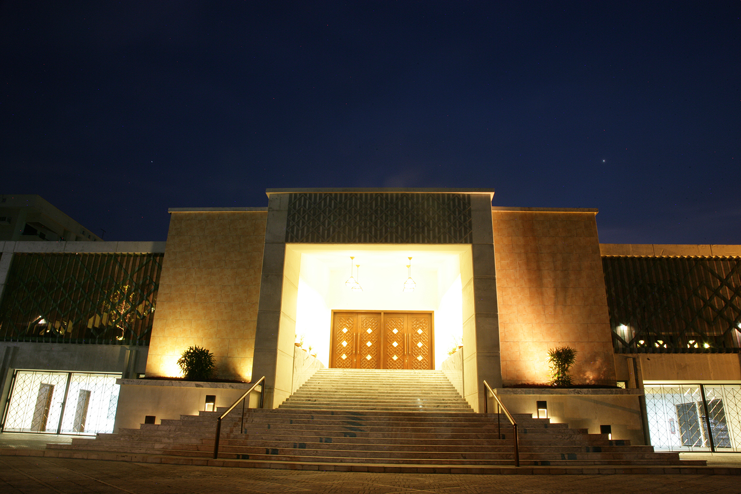 An evening view of the Dhaka Ismaili Jamatkhana and Centre, with a lighted marble stairway leading to the main entrance. Photo: Ayeleen Ajanee Saleh