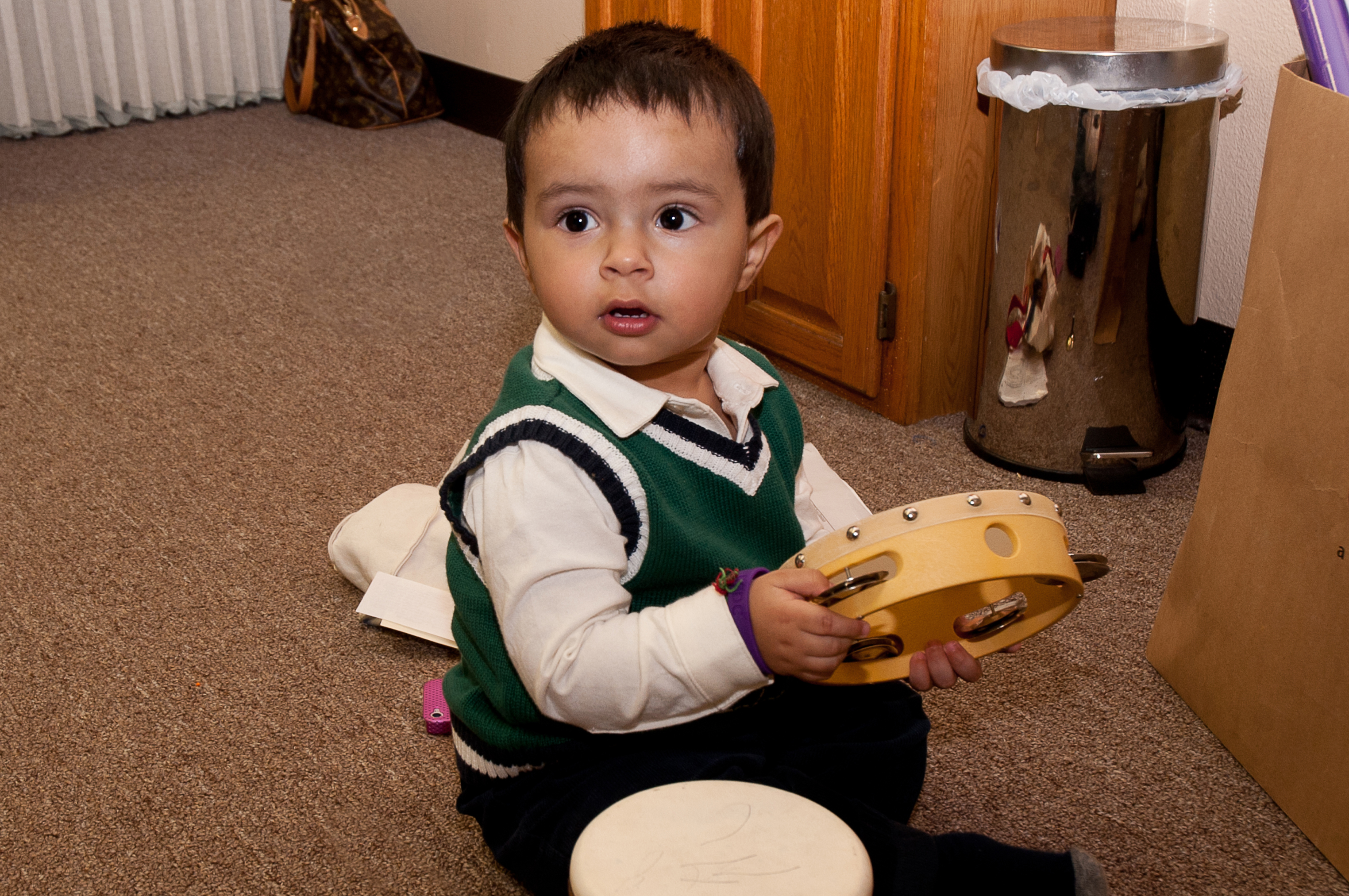 Little Raahil plays with a tambourine as part of a Marching Band activity held in Los Angeles. Photo: Shams Soomar