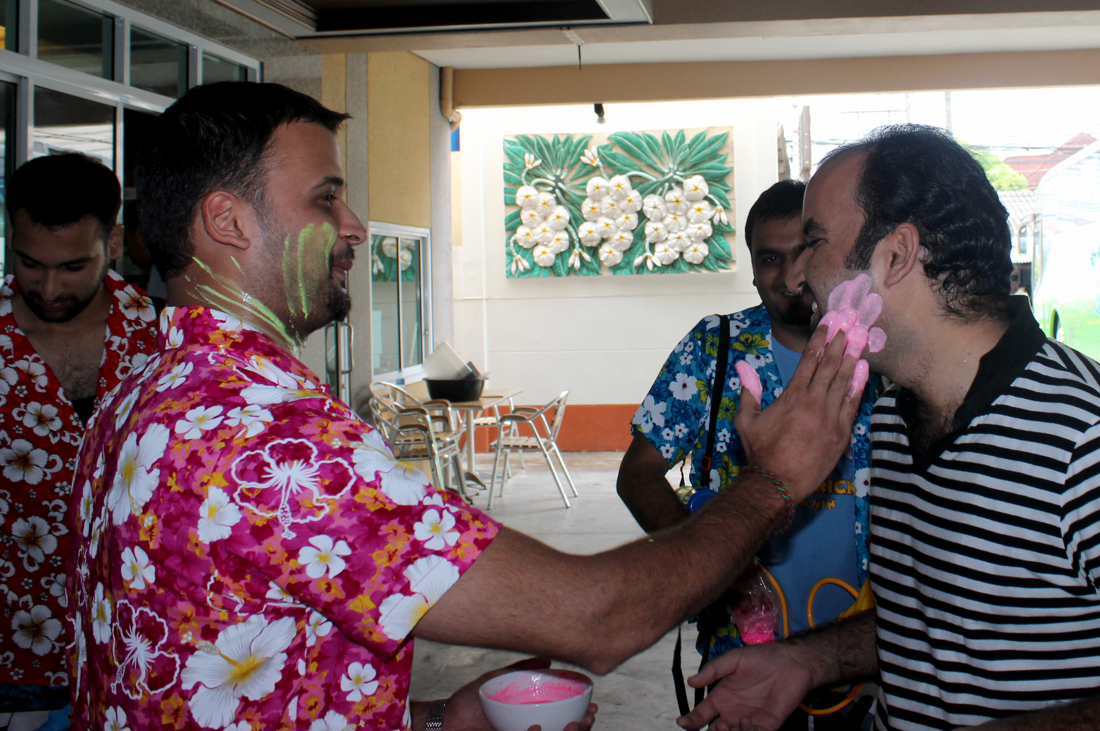 An Ismaili from Thailand smears chalk paste on a visiting member of the group: a Thai tradition of sharing blessing during Songkran. Photo: Naeem Ullah Khan and Shaakir Siraj