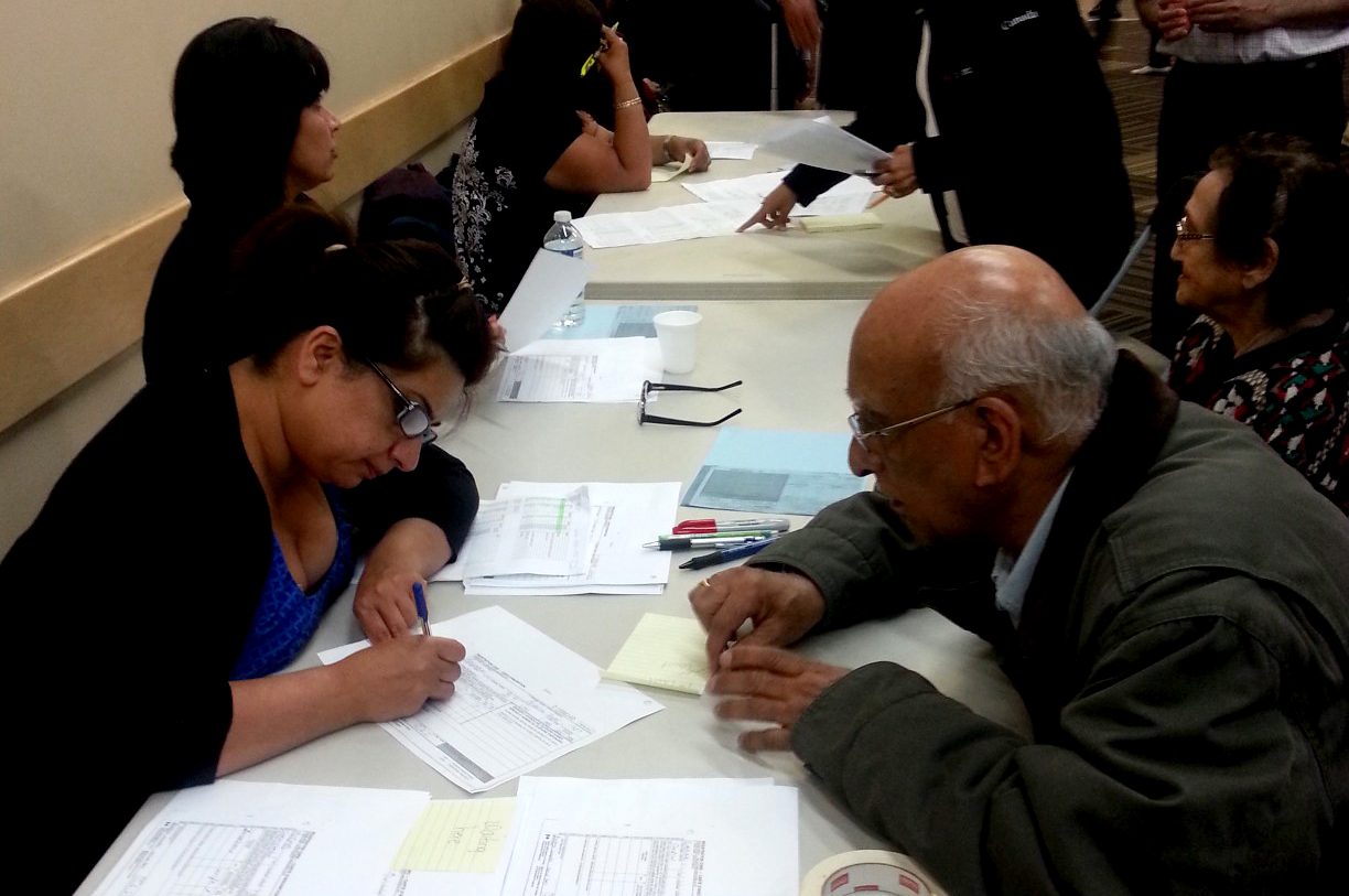 Ismaili volunteers register Jamati seniors who were evacuated from their apartments in downtown Calgary on the evening of 21 June 2013. Photo: Moshin Ukani