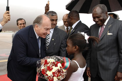 Anne Marie Mirembe welcomes Mawlana Hazar Imam with flowers in the presence of Martin Aliker, Advisor to the President of Uganda, Mayor Sebaggala, Yusuf Karmali, President of the Ismaili Council for Uganda and Mahmood Ahmed, Resident Representative of the AKDN, Uganda. Photo: AKDN/Gary Otte