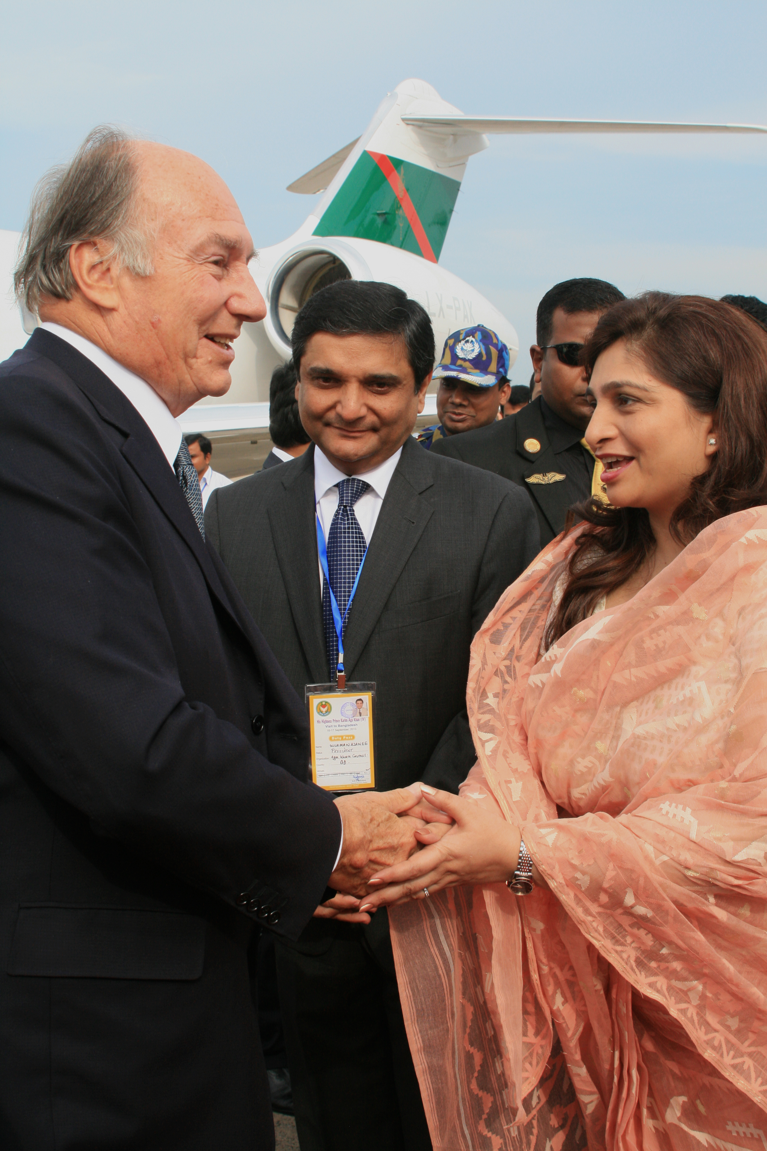 Mawlana Hazar Imam is welcomed to Bangladesh by President Banoo, as Ismaili Council President Rai Sulaiman Ajanee looks on. Photo: TheIsmaili / Ayeleen Ajanee Saleh