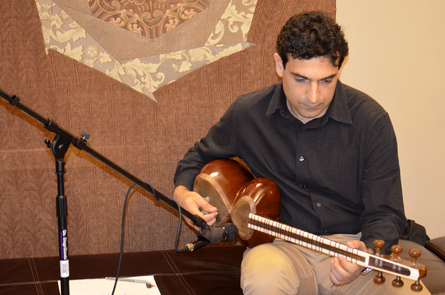 A musician plays the rubab at the Enlightened Encounters outreach event held  at Chicago Headquarters Jamatkhana in Glenview, IL. Photo: Courtesy of the Enlightened Encounters team