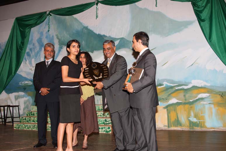 Nishala B. receiving an award from Yusuf Karmali,President of the Ismaili Council for Uganda. Photo: Zahir Rehemtulla.