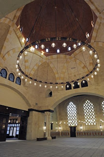 The congregational hall of the Ismaili Centre Dubai features the building`s largest dome. Its octagonal shape is supported by meticulously engineered heavy corbels, which dominate the space. The ambience is set by the enormous brass chandelier from Egypt. Photo: Gary Otte